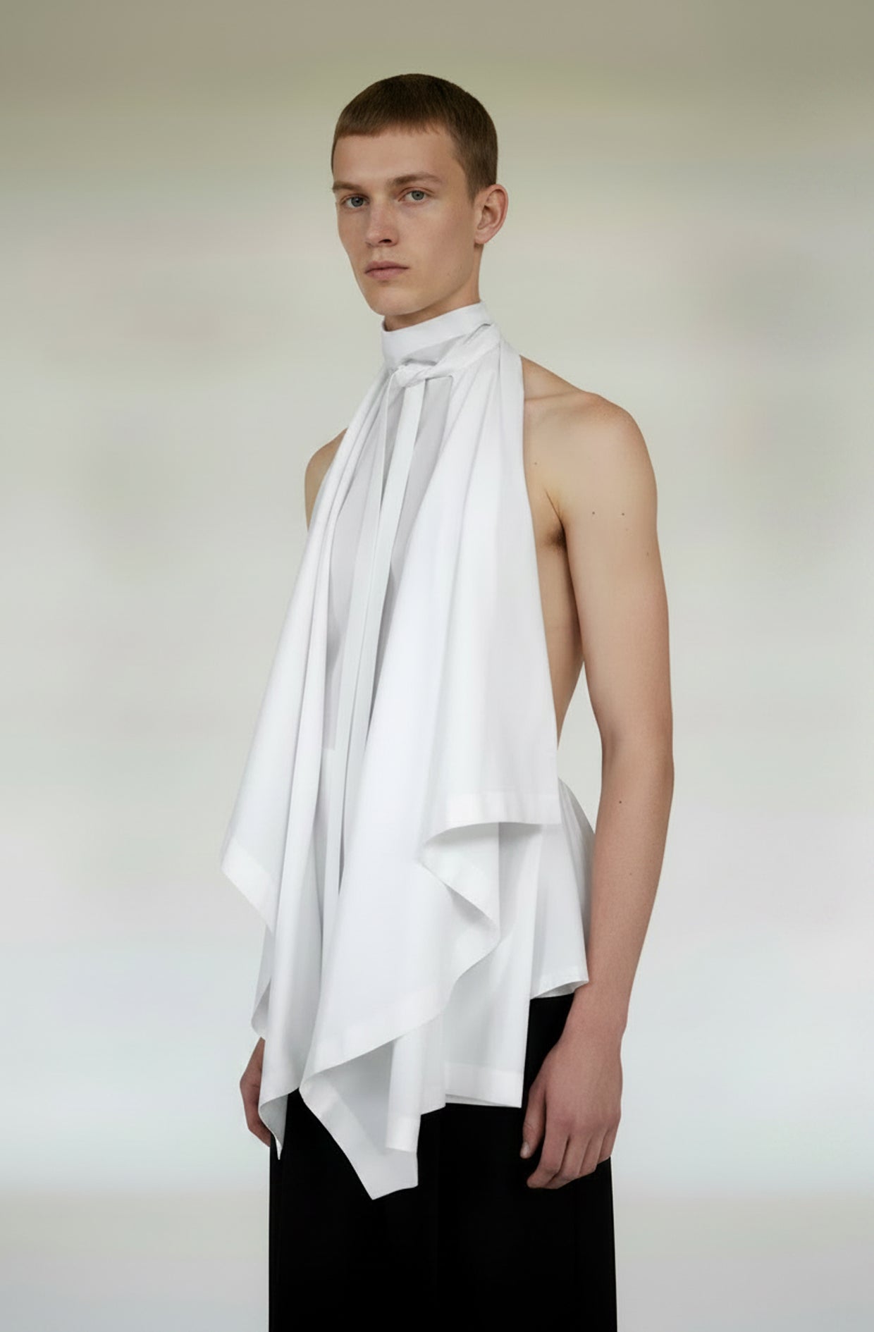 Male model wearing the unisex white color blanket top a zero waste design by Cunnington & Sanderson