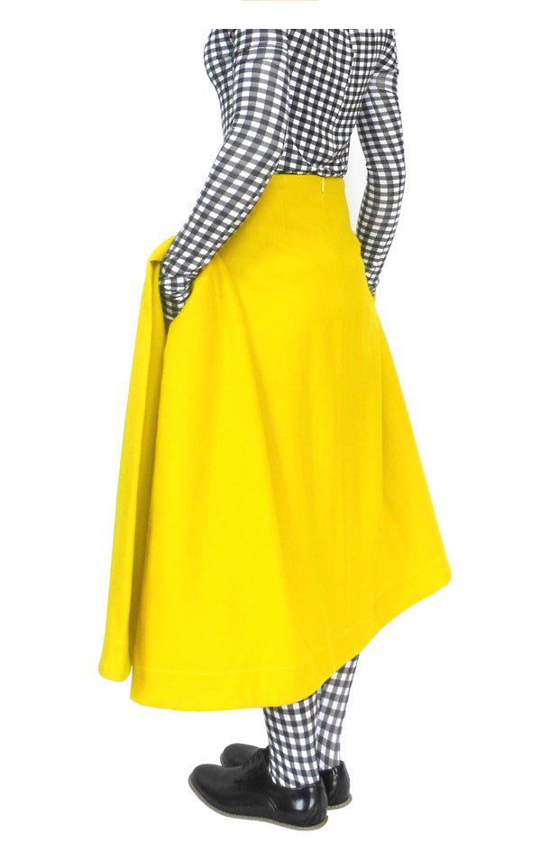 Side view of the blanket pocket skirt with large, luxury, elegant fabric folds