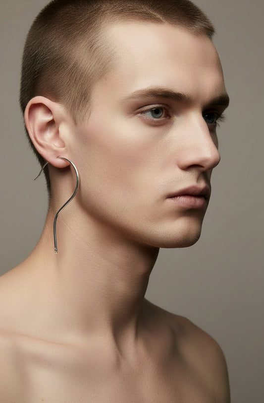 Silver question mark wire earring worn by male model, close-up profile view — minimalist silver jewellery, handmade in the Paris
