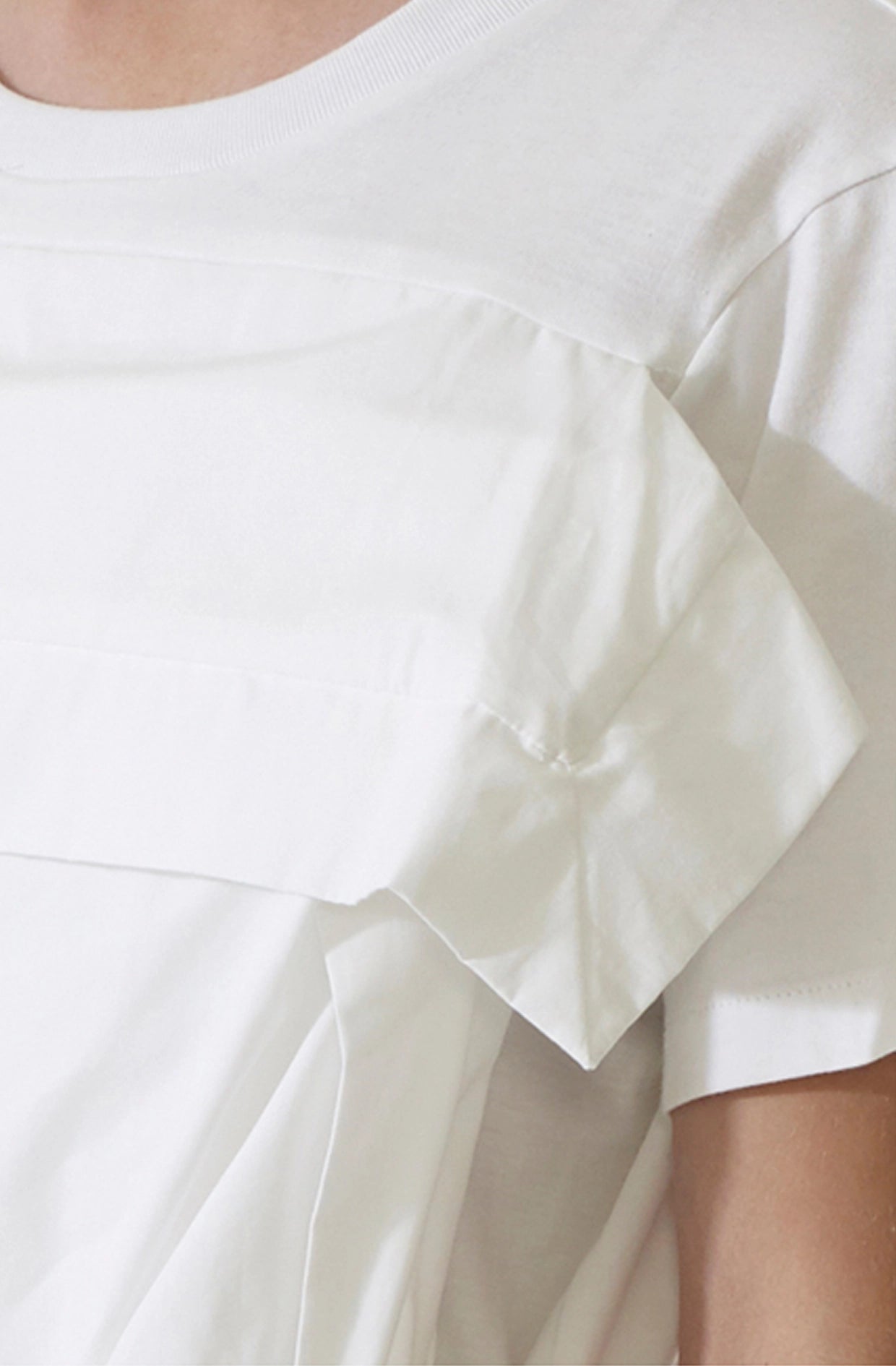 Close-up of a white t-shirt top with attached pillow case in organic cotton