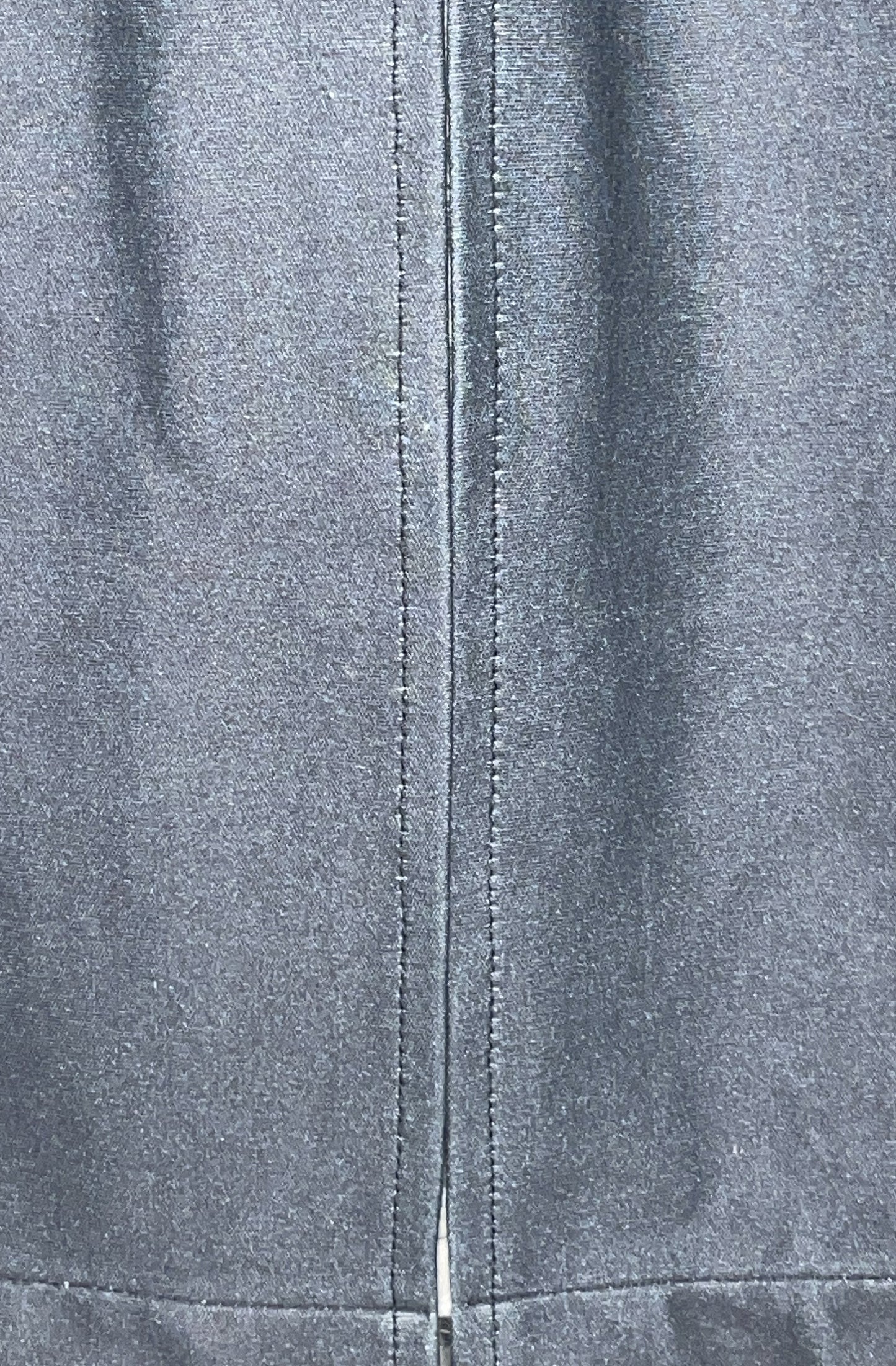 Close-up of the zero waste dress black organic cotton fabric texture back vent