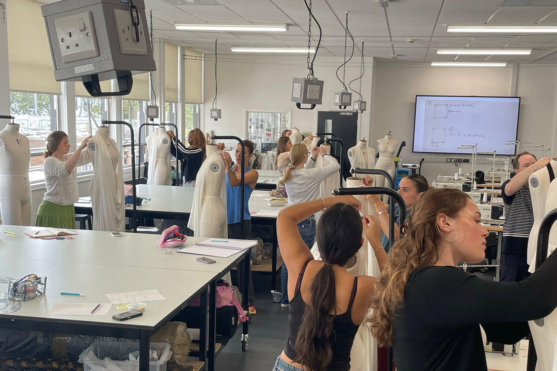 Loughborough University fashion students draping fabric on dress stands at Cunnington & Sanderson’s No Wasted Jam workshop.