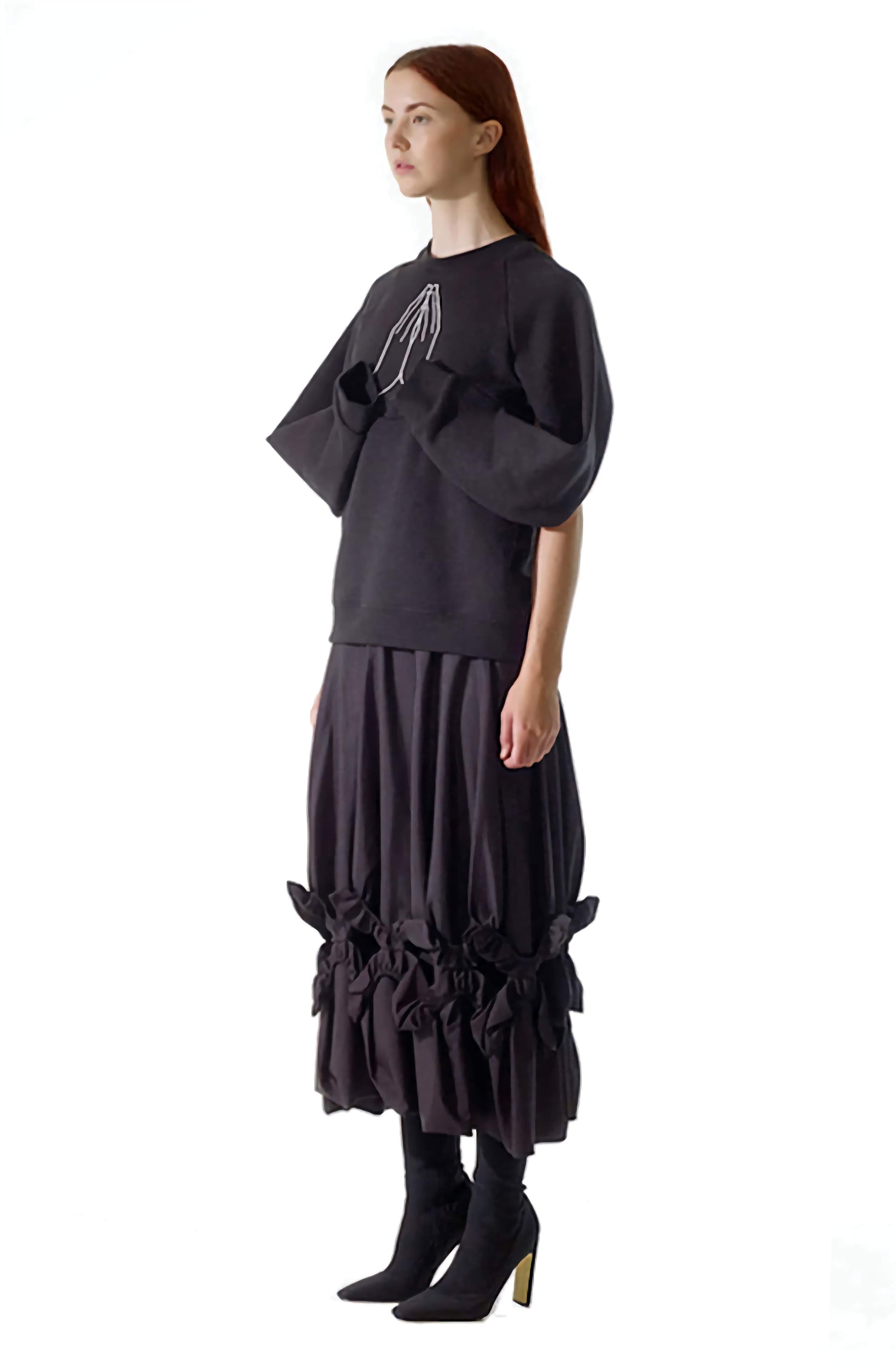 Flattering side view of the black organic cotton hope sweatshirt top, with unique, creative draped sleeves 