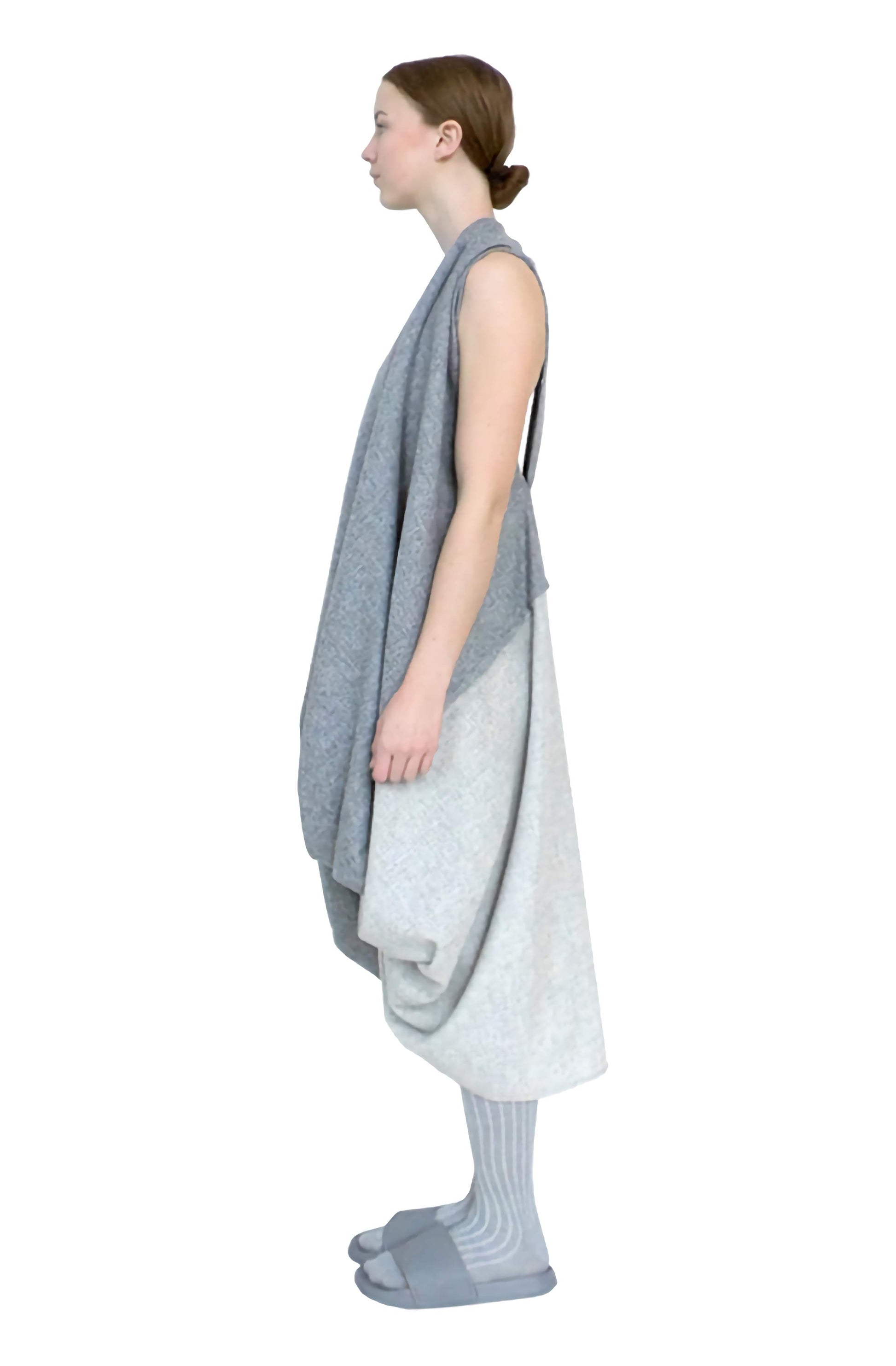 Side view of the grey sculptural and elegant wool knotted dress, a zero waste sustainable fashion piece.
