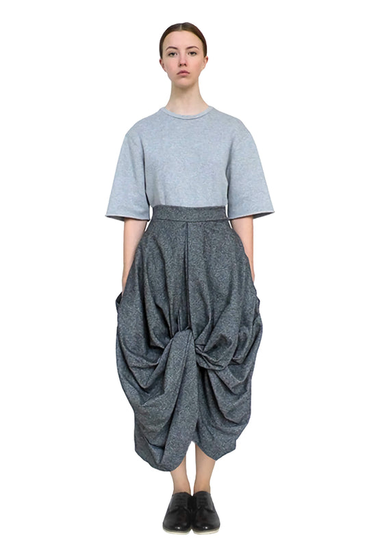 Contemporary and modern long length skirt with voluminous drape in to a good luck knot.