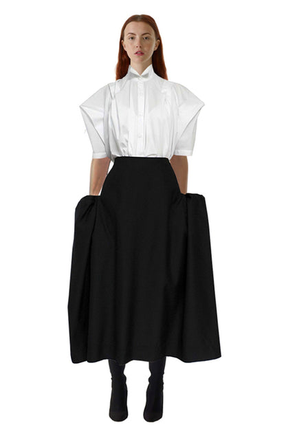 Zero-waste black cotton blanket skirt with boxy silhouette and pockets, sustainable luxury made-to-order in UK