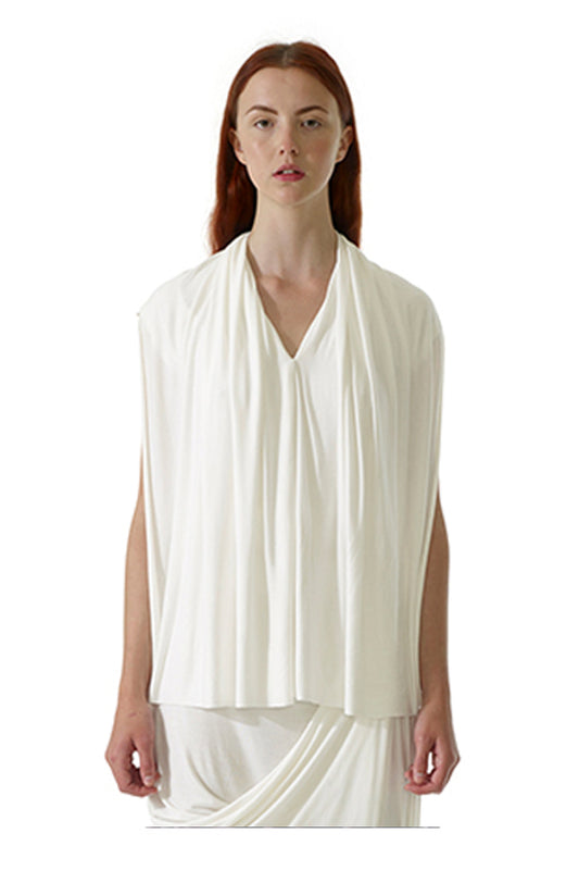Close up image of model wearing an elegant drape white top with v neckline and artistic boy silhouette