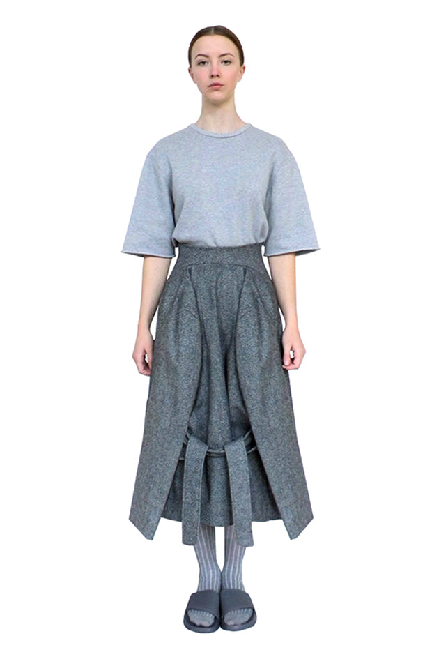 model wears luxury designer grey wool skirt by cunnington & sanderson exhibited internationally and acquired by museums