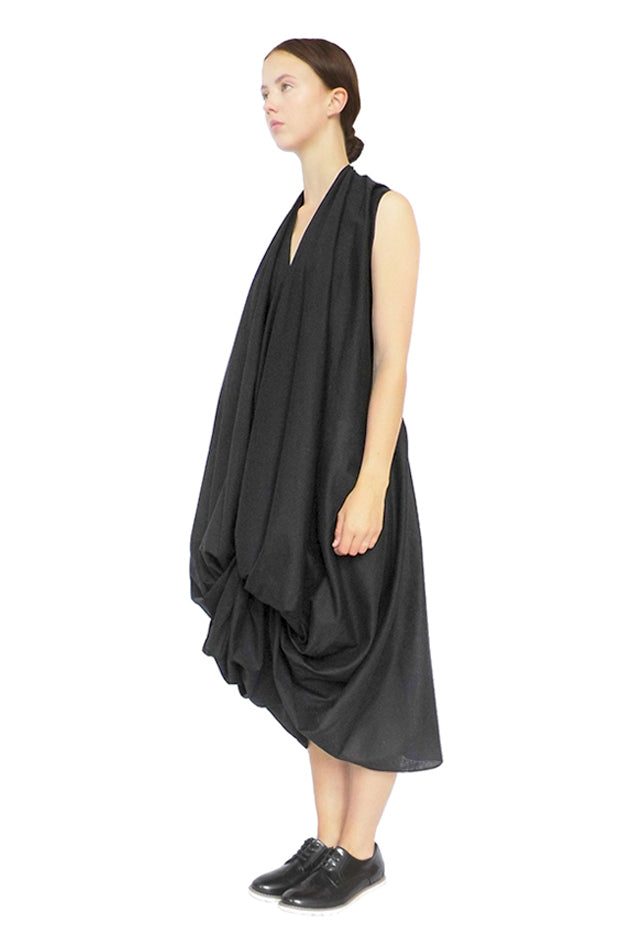 contemporary artisan luxury black dress draped by hand this zero waste sustainable fashion piece with a sculptural silhouette