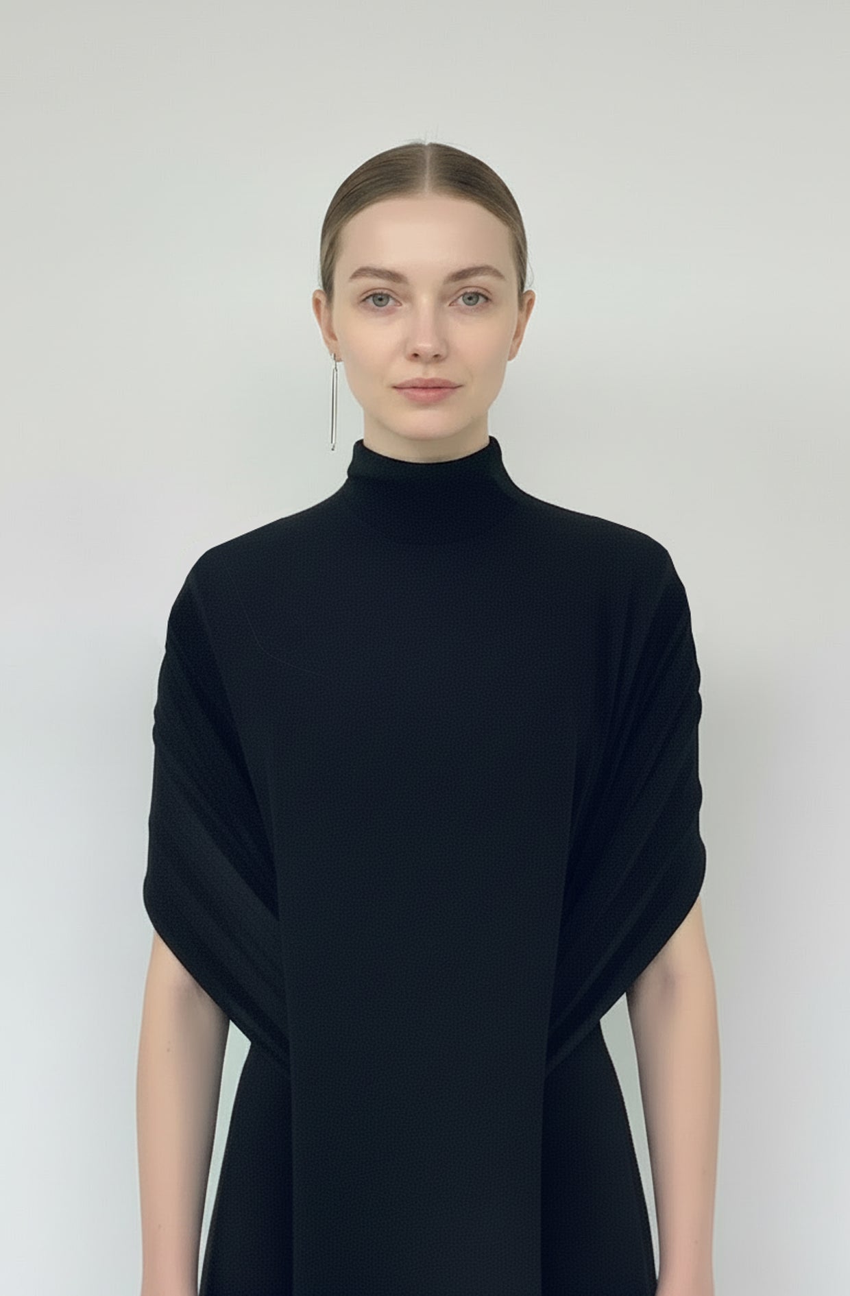 Echelon Dress model close-up showing cape and mock turtleneck in black viscose jersey by Cunnington & Sanderson