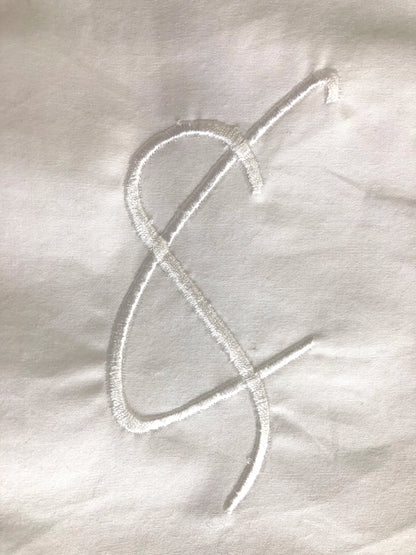 Cunnington & Sanderson embroidered logo on organic cotton, sustainable UK-made luxury detail