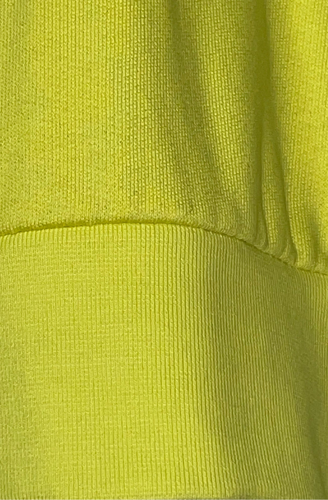 Close-up of a bright yellow heart sweater fabric texture rib by Cunnington & Sanderson