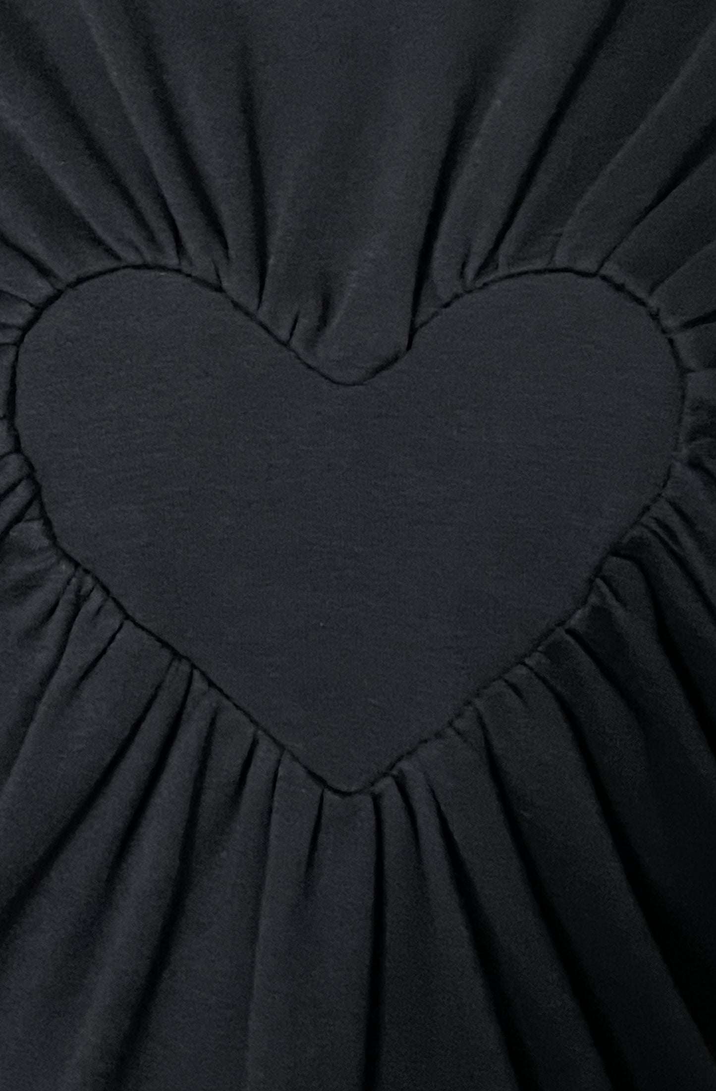 Close up of the black organic cotton heart t-shirt with gathered edges
