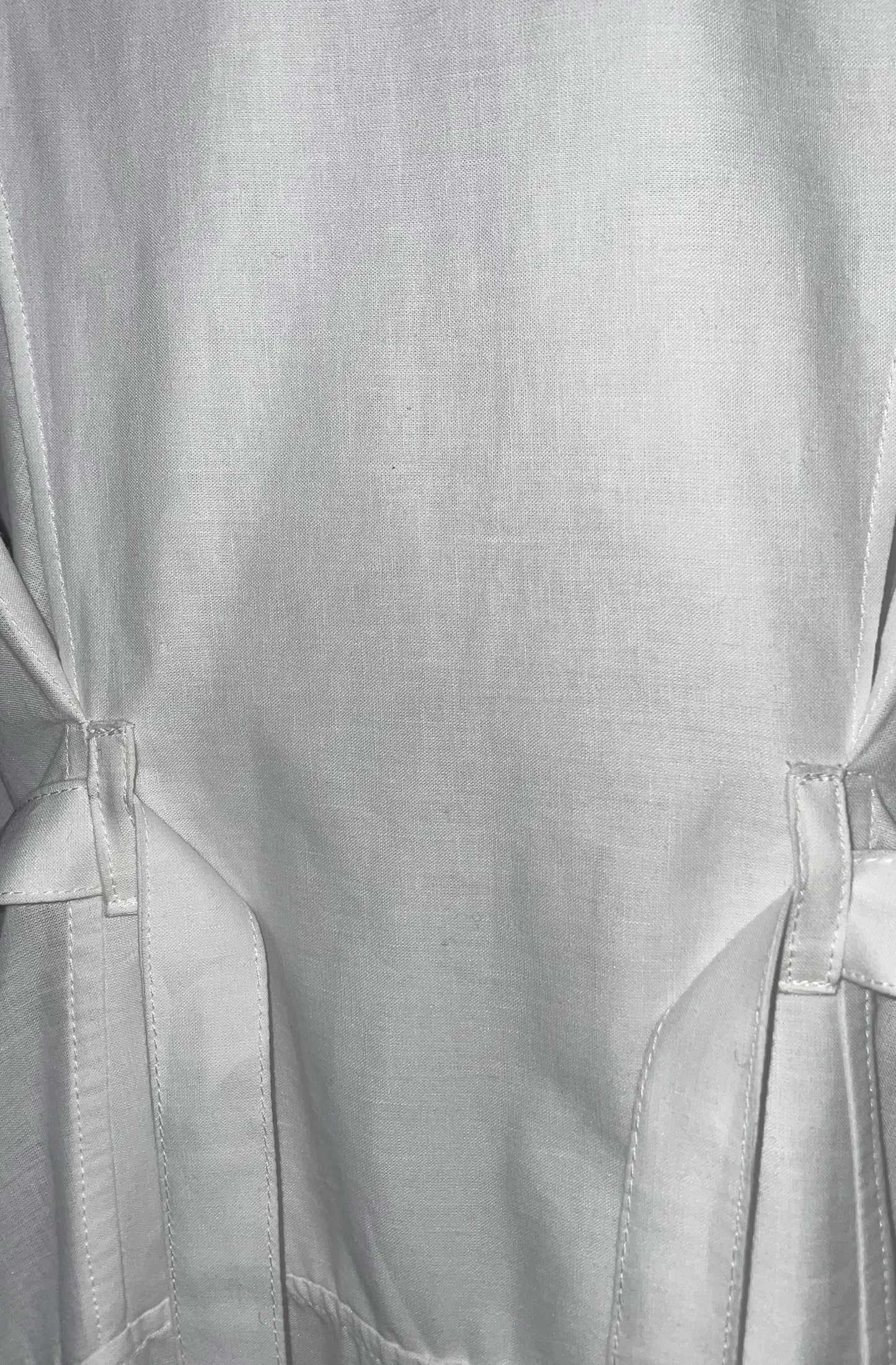 Close-up of zero waste white cotton fabric with belt and belt loop details