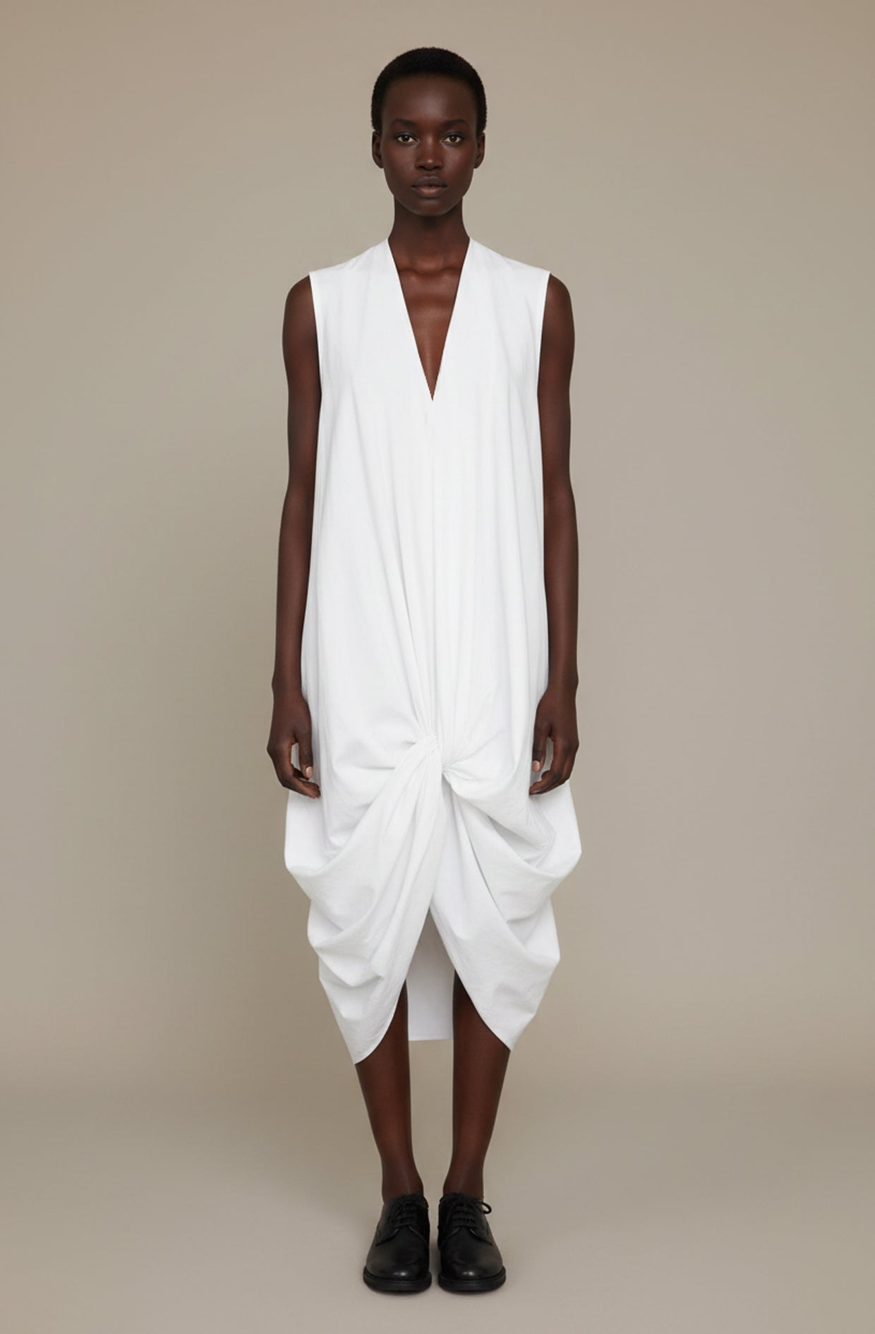 White knotted dress with crafted good luck knot structure, zero-waste sustainable made-to-order UK