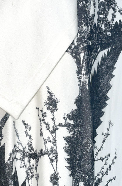 Close-up of a black nettle print pattern on white organic cotton zero waste nettle dress