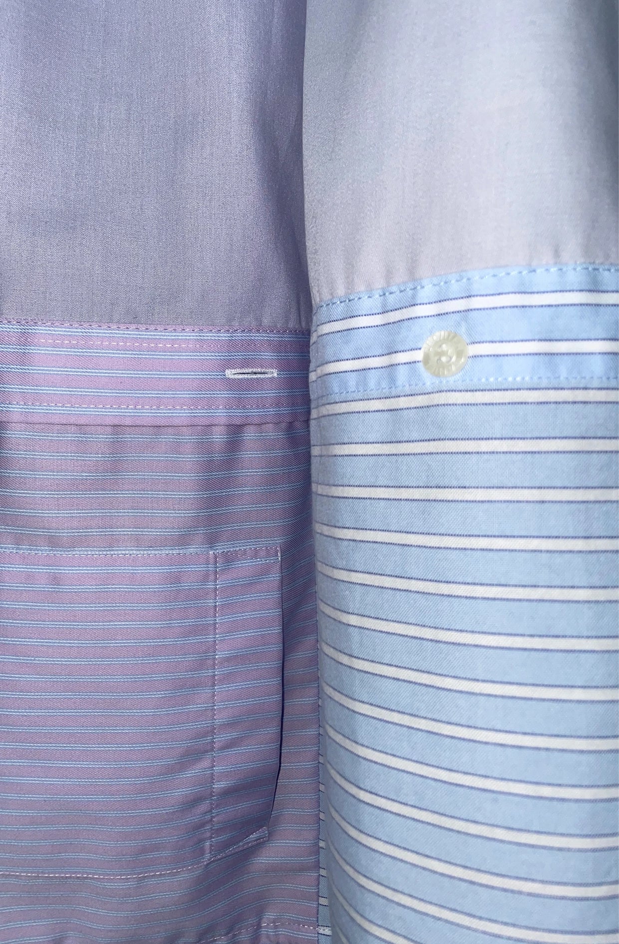 Close-up of two shirts with striped patterns in purple and blue.