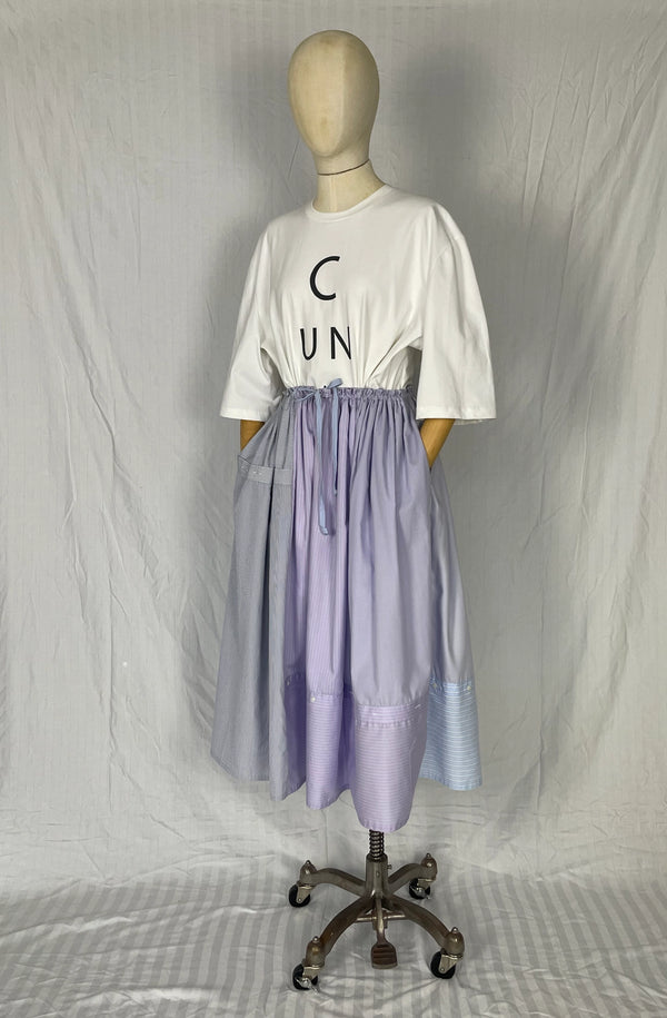 Mannequin wearing a white t-shirt with text and a recycled purple skirt on a plain background UK made